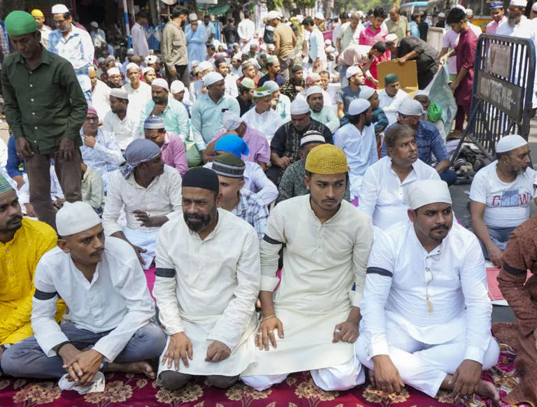 काली पट्टी बांधकर नमाज़ अदा करते लोग